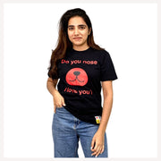A person wearing a black unisex t-shirt with text and a graphic related to pets.