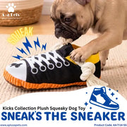 A fawn pug dog plays with a plush sneaker-shaped dog toy, biting and pulling at the rope laces. The toy is black with white laces, a yellow collar, and an orange rope sole.