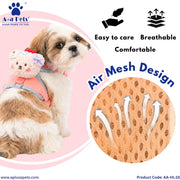 A small fluffy dog wearing a pink pet harness with a plush bear accessory, shown on a pink graphic background with product feature icons and an inset close-up of the breathable mesh fabric. Brand text 'A+o Pets' and website text are visible.