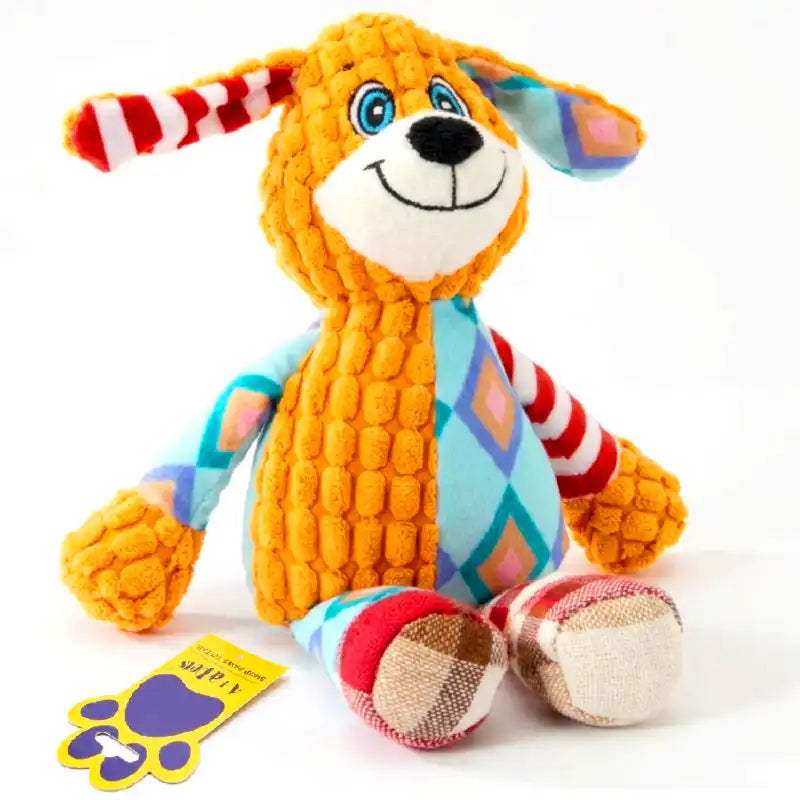 A colorful plush dog toy made of textured cord fabric, sitting on a white background with its yellow tag in front.