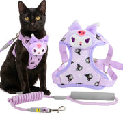 A black cat wearing a lavender and purple Kuromi-themed pet harness and leash, shown alongside the harness and leash laid out on a white background.