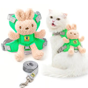A plush pet harness set shown on a white cat and as a standalone product. The harness features a soft tan bunny plush attached to a bright green vest, with gray adjustable straps and a matching gray leash.