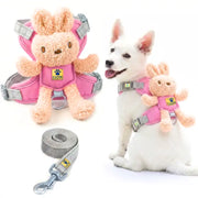 Pink dog harness with a plush bunny attachment and gray leash, shown both as a standalone product and worn by a white dog on a white background.