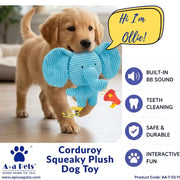 A golden retriever puppy carrying a blue corduroy plush elephant toy in its mouth while walking on a wooden floor. The image includes text overlays describing the toy's features and brand, 'Aplus Pets'.