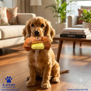 A golden retriever dog sits on a wooden floor in a living room, holding a plush hot dog toy in its mouth. The toy has brown dog ears and a yellow hot dog body.