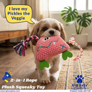 A small dog carries a pink crocheted vegetable-shaped plush toy with green leaf-like feet and a multicolored rope toy attached, in a bright indoor room. A speech bubble says, "I love my Pickles the Veggie," and the image includes branding and product text for a 2-in-1 rope plush squeaky toy.